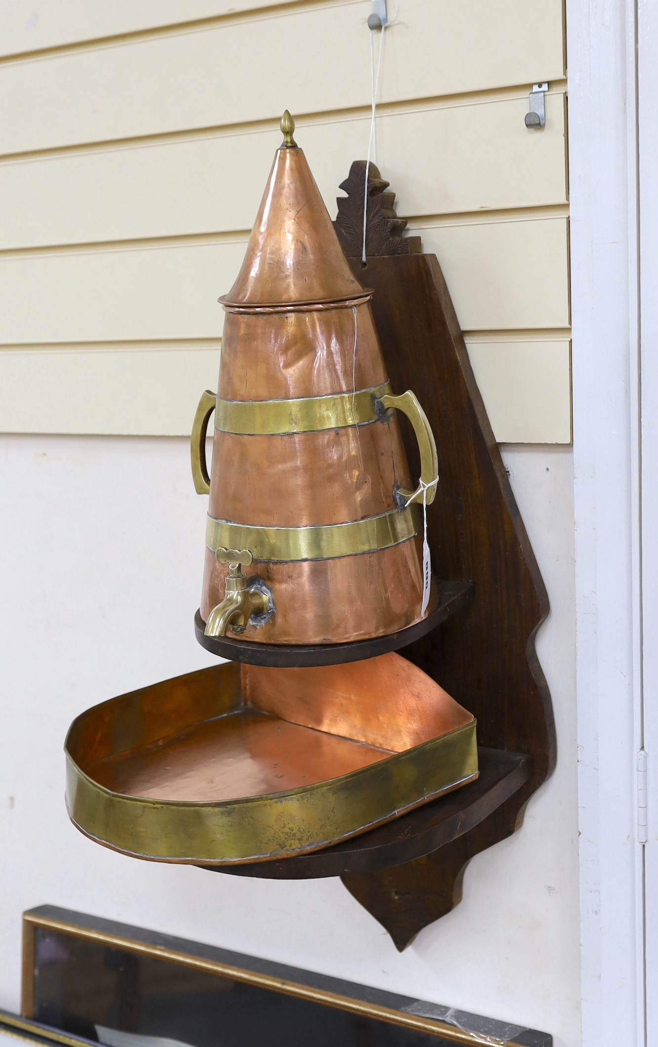 A copper and brass oil tap, tray and stand
